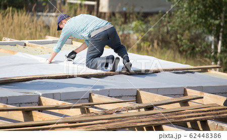 Workers cut the roof in the house 62448386