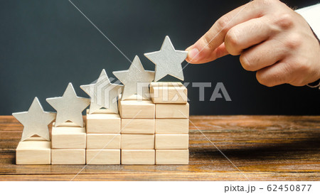 Critic puts the fifth star. The concept of the rating of hotels and restaurants. The evaluation of visitors. Quality level, good service. Best customer rating. Feedback. Satisfaction Critic puts the fifth star. The concept of the rating of hotels and restaurants. The evaluation of visitors. Quality level, good service. Best customer rating. Feedback. Satisfaction 62450877