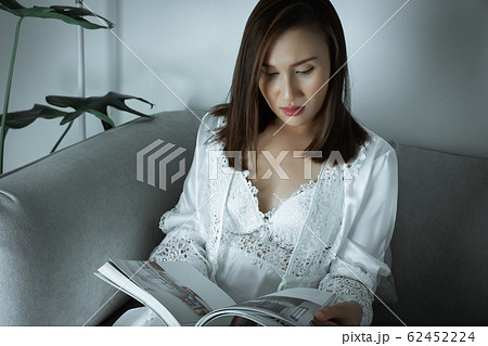 Women reading the magazine article. 62452224