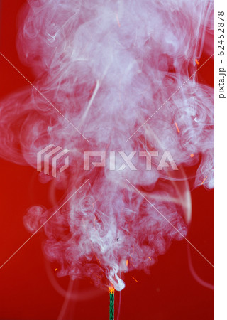 Pyrotechnics wick fuse burning with smoke and sparks on red background Pyrotechnics wick fuse burning with smoke and sparks on red background 62452878