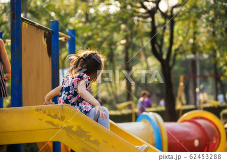 Girl play slider in playground Girl play slider in playground 62453288