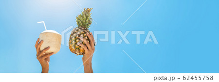 Panoramic photo of Hands Holding Fruits in Tropical Paradise Over Sky Background Panoramic photo of Hands Holding Fruits in Tropical Paradise Over Sky Background 62455758