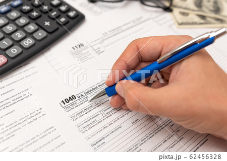 Man filling US tax form in office 62456328