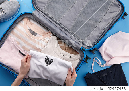 Woman packing travel suitcase 62457488
