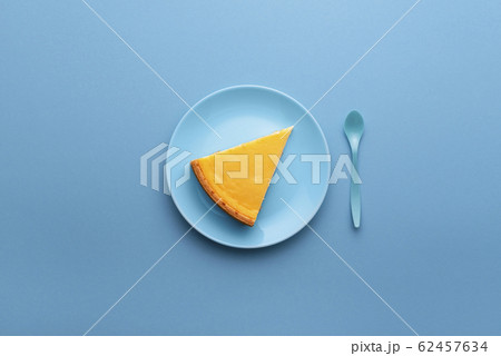 Cheesecake slice on blue plate. One piece of 62457634