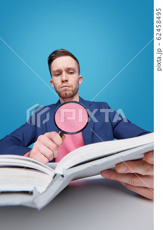 Reading through magnifying glass 62458495