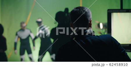 Director watching a shooting and discussing with an actor Director watching a shooting and discussing with an actor 62458910