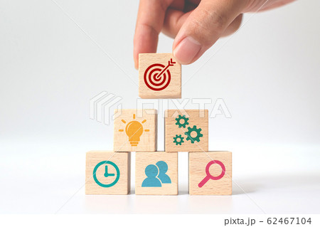 Concept of business strategy and action plan. Hand putting wooden cube block stacking with icon 62467104
