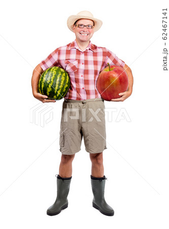 Gardener holding water melon and red apple; Gardener holding water melon and red apple; 62467141