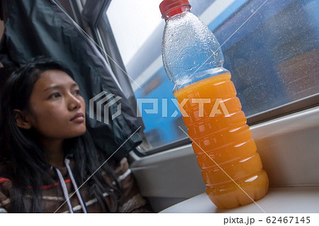 young woman riding by railway and look out of the young woman riding by railway and look out of the 62467145
