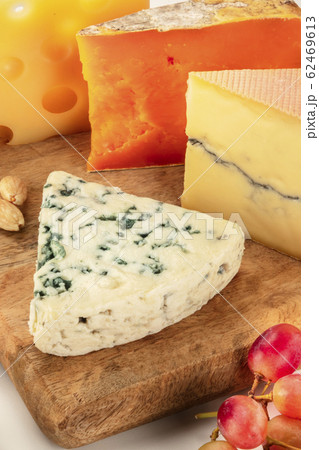 Cheese platter. Blue cheese, goat cheese etc, a close-up on a wooden board Cheese platter. Blue cheese, goat cheese etc, a close-up on a wooden board 62469613