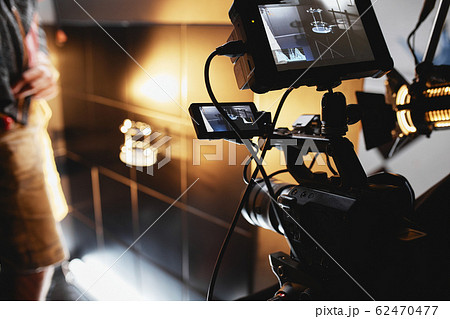 Video production backstage. Behind the scenes of creating video content, a professional team of cameramen with a director filming commercial ads. Video content creation, video creation industry. Low 62470477