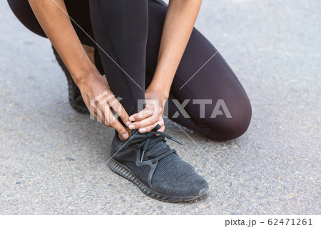 Close up Athlete running woman use hands hold on his ankle while running in the morning.Ankle injury on woman after traning for warm up her muscle. Close up Athlete running woman use hands hold on his ankle while running in the morning.Ankle injury on woman after traning for warm up her muscle. 62471261