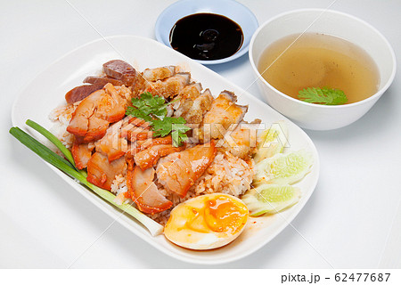 Barbecued red pork and crispy pork in sauce with rice, Chinese style roasted pork. 62477687