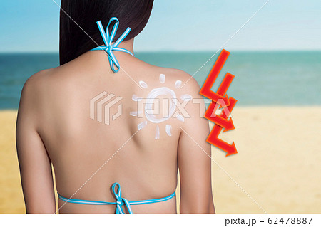 UV reflection skin after protection. Skin care concept. Woman applying sunscreen on her back with sea background. SPF sunblock protection concept. Travel vacation 62478887