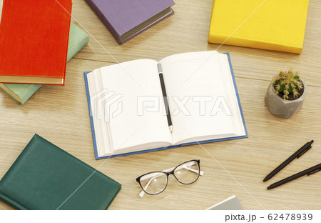 Close up of open book with glasses and cactus 62478939
