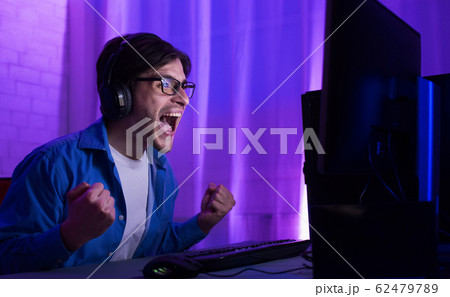 Gamer At Computer Winning Gaming Tournament Shouting Celebrating Victory Indoor 62479789