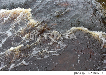 Waterfall with a huge current, mountain waterfall. 62480764