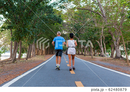 Back view senior couple jogging in the public park. Back view senior couple jogging in the public park. 62480879