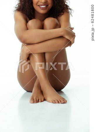 Slim tanned woman's body isolated on white studio background Slim tanned woman's body isolated on white studio background 62481800