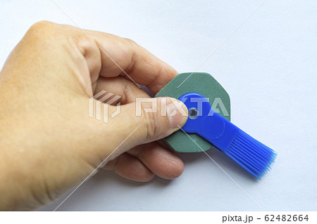 Woman's left hand holding vintage pen round rubber eraser with brush, Close up shot, Stationery concept Woman's left hand holding vintage pen round rubber eraser with brush, Close up shot, Stationery concept 62482664