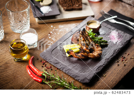 Tasting menu. Beef steak and grilled tiger prawns. Tasting menu. Beef steak and grilled tiger prawns. 62483473