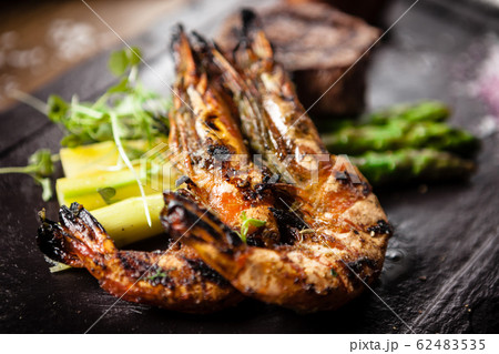 Tasting menu. Beef steak and grilled tiger prawns. Tasting menu. Beef steak and grilled tiger prawns. 62483535