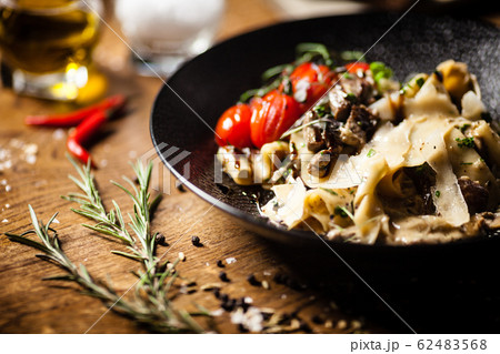 Black Angus Pasta served in a black bowl in restaurant 62483568
