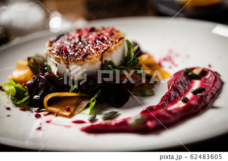 Grilled goat cheese salad served on a plate in restaurant 62483605