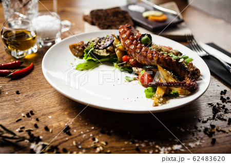 Octopus salad served on a plate in restaurant 62483620