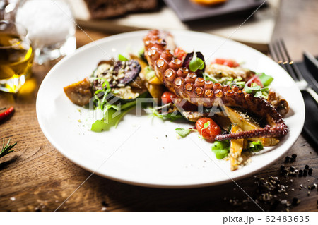 Octopus salad served on a plate in restaurant 62483635