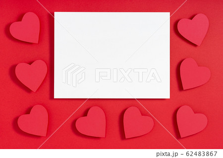 Valentine hearts with shadow, blank sheet of paper, template for design on red surface Valentine hearts with shadow, blank sheet of paper, template for design on red surface 62483867