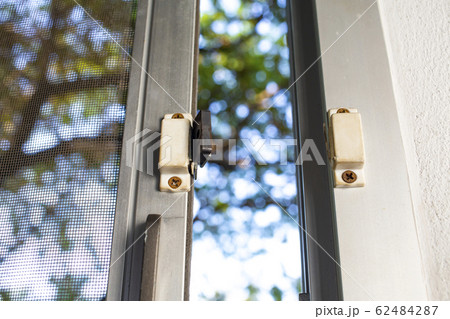 Broken security magnetic lock contact for mosquito wire screen window, Repair Room concept Broken security magnetic lock contact for mosquito wire screen window, Repair Room concept 62484287