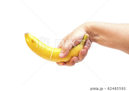 Condom on banana in hand isolated on white 62485593