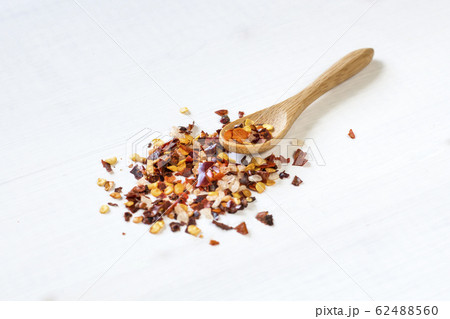 chilli powder on wooden spoon 62488560