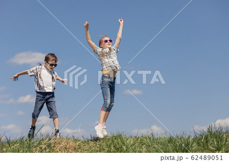Brother and sister playing on the field 62489051