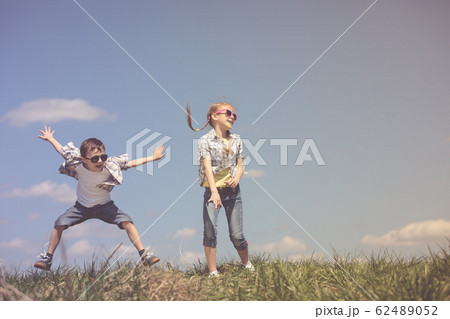 Brother and sister playing on the field Brother and sister playing on the field 62489052