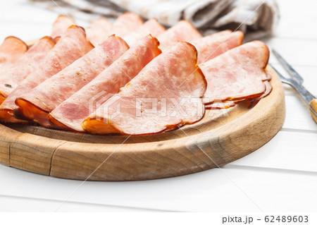 Sliced salami sausage. Smoked ham. 62489603