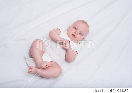 Newborn baby asleep on white blanket. Cute baby in 62491885