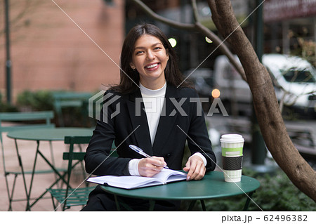 Happy smiling business woman having coffee break 62496382