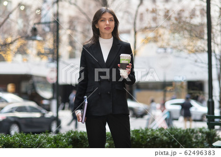 Happy smiling business woman having coffee break 62496383