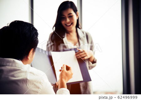 Asian manager rise hand to ask question during sale woman present summary report in meeting room 62496999