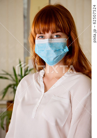 redhead girl in a protective bandage on her face redhead girl in a protective bandage on her face 62507524