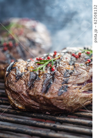 Juicy beef rib eye steaks on the grill with Juicy beef rib eye steaks on the grill with 62508132