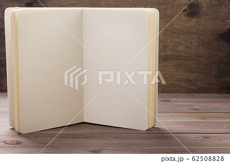 notepad or paper book at wooden table notepad or paper book at wooden table 62508828