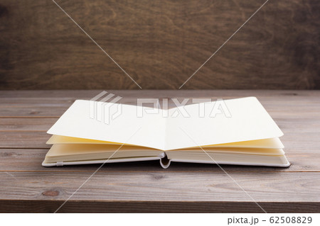 notepad or paper book at wooden table 62508829