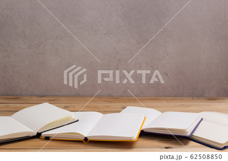notepad or paper notebook at wooden table notepad or paper notebook at wooden table 62508850