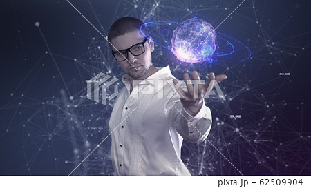 A male scientist in a white shirt holds an abstract ball in his hands against a background of plexus A male scientist in a white shirt holds an abstract ball in his hands against a background of plexus 62509904