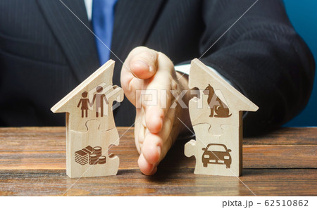 Puzzle house is divided into two equal parts by a lawyer in a divorce process. Protection of rights. Conflict resolution. Court, justice. Disputes over fair division of marital property real estate. Puzzle house is divided into two equal parts by a lawyer in a divorce process. Protection of rights. Conflict resolution. Court, justice. Disputes over fair division of marital property real estate. 62510862
