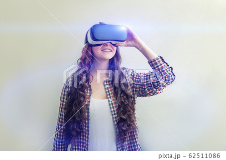 Smile young woman wearing using virtual reality VR Smile young woman wearing using virtual reality VR 62511086